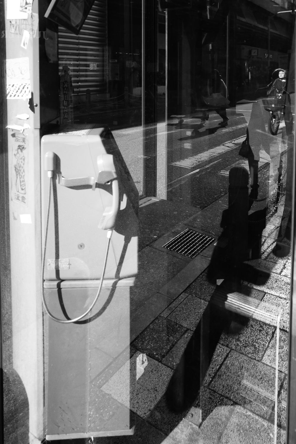 Reflections in a phone booth near Akabane Station.