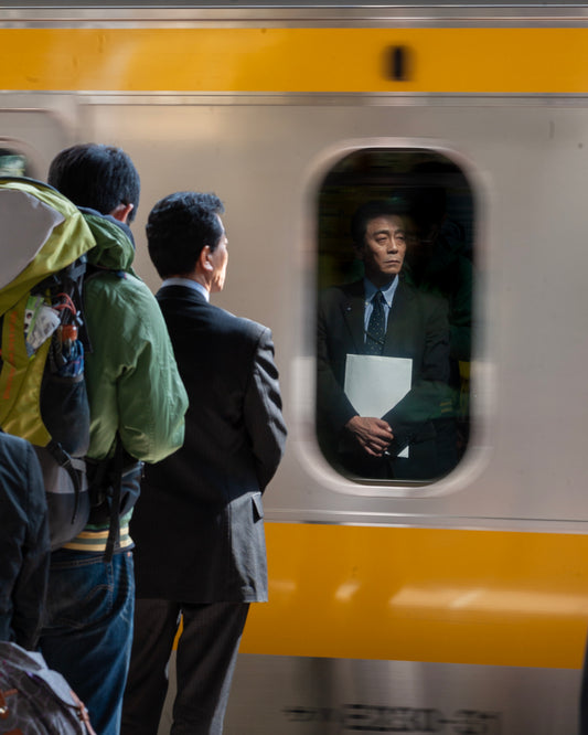 Reflection of a commuter in a passing train, Akihabara, Tokyo.