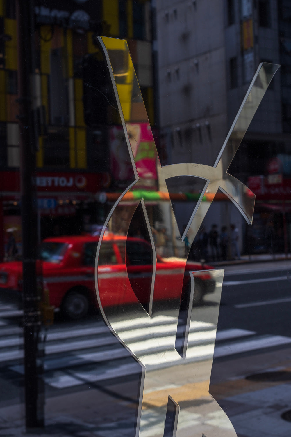 Reflection of a taxi in an Ikebukuro department store window.
