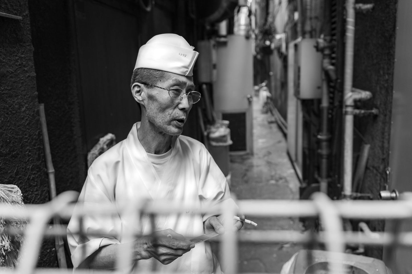 A cook on a cigarette break, Ueno alley.