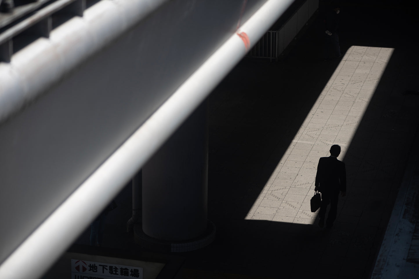 A man walk into the light near Kawaguch Station.
