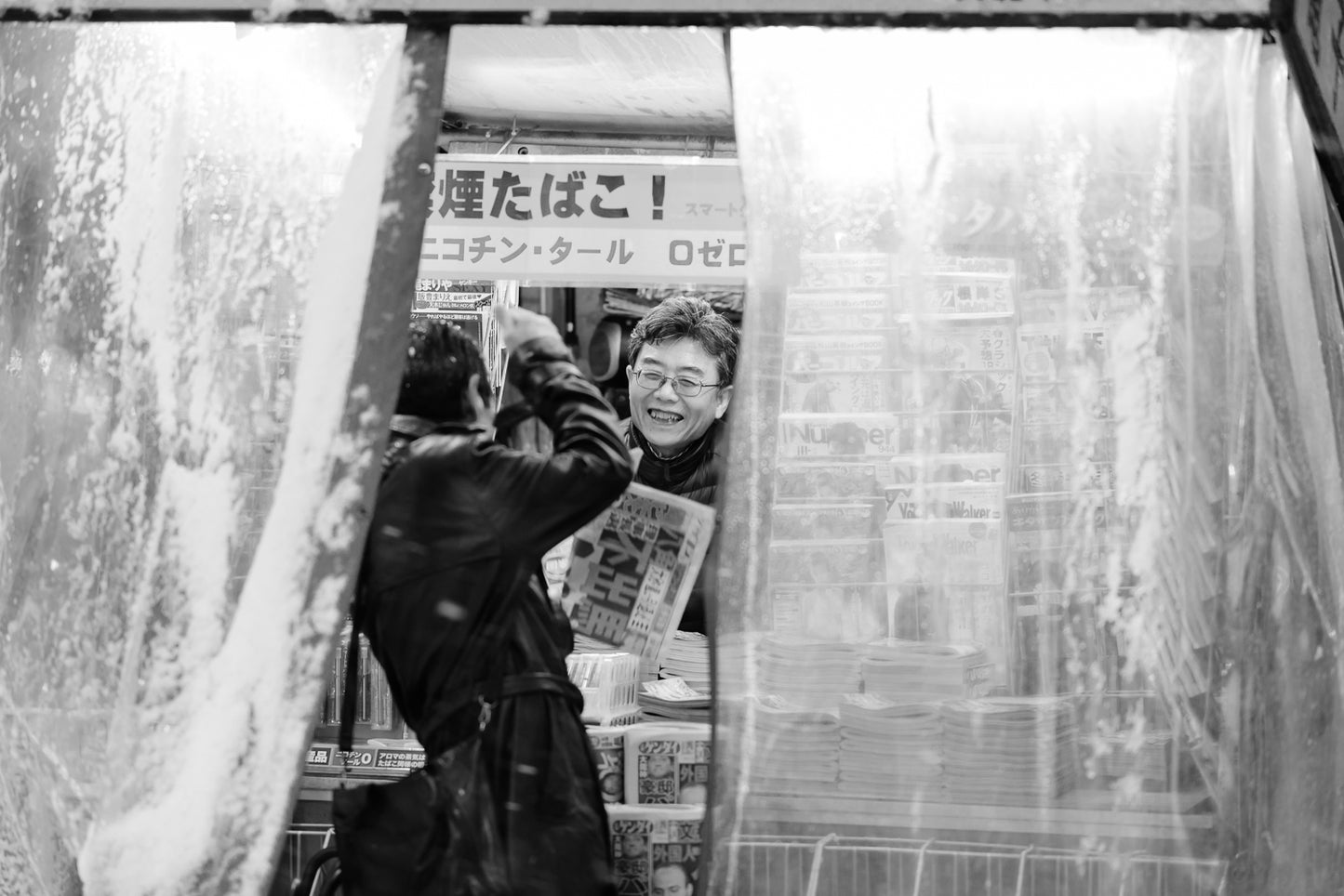 A man buys a news paper from a stand in Shibuya - Tokyo Photo Tour