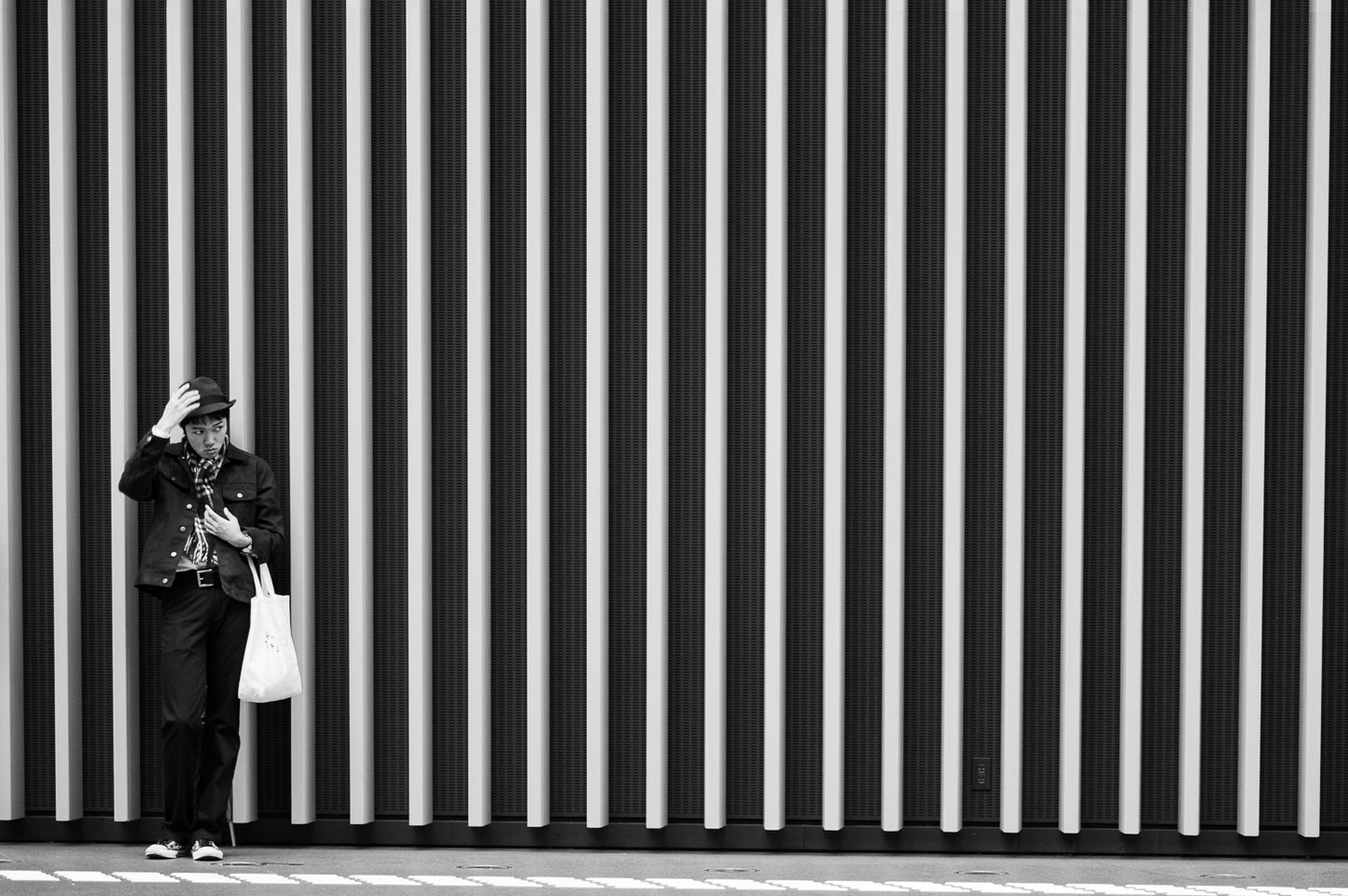 A man checks his hat at the Tokyo International Forum.