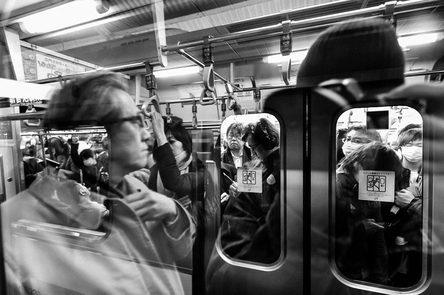 Reflections of commuters inside a waiting train, Shibuya.