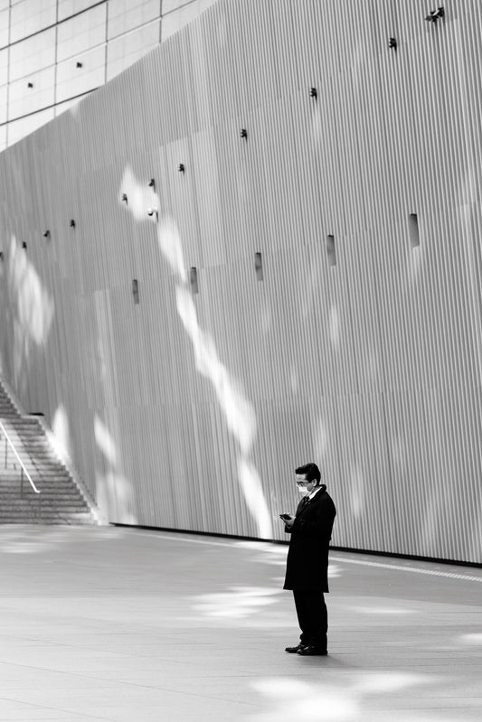 A man checks his phone in the Tokyo International Forum