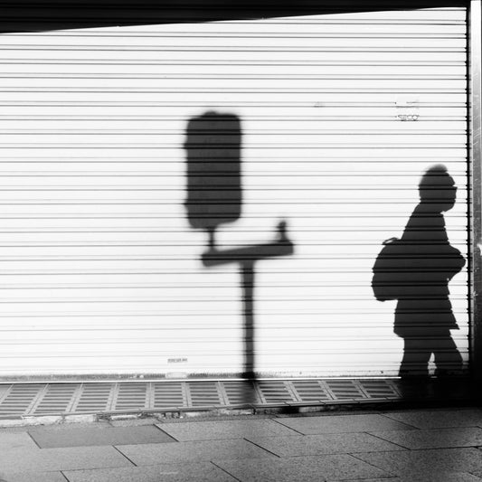 A shadow of commuter and a stop light in Akabane.