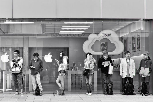 A woman makes eye contact standing line at the Apple Ginza store.