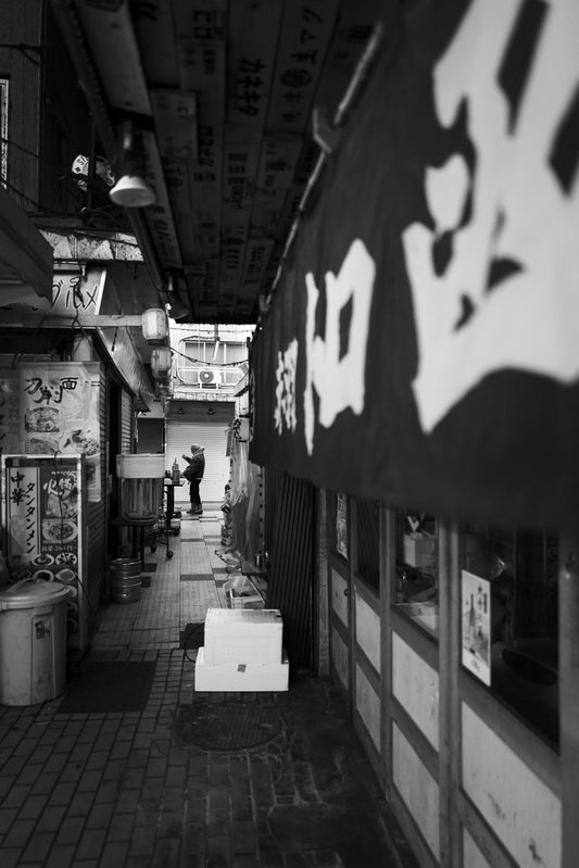 A man drinks in an Akabane secret alleyway 