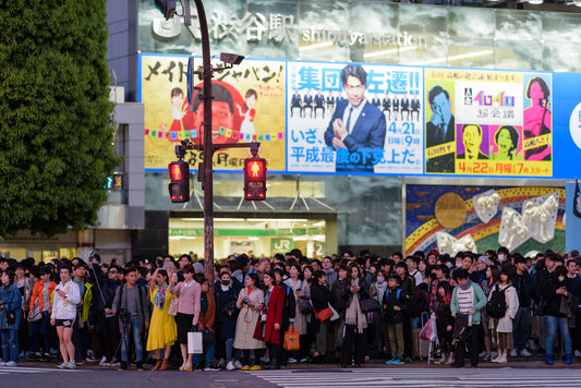 The crowd is aglow from the bright neon lights eagerly awaits the street light at Shibuya's famed scramble crossing.