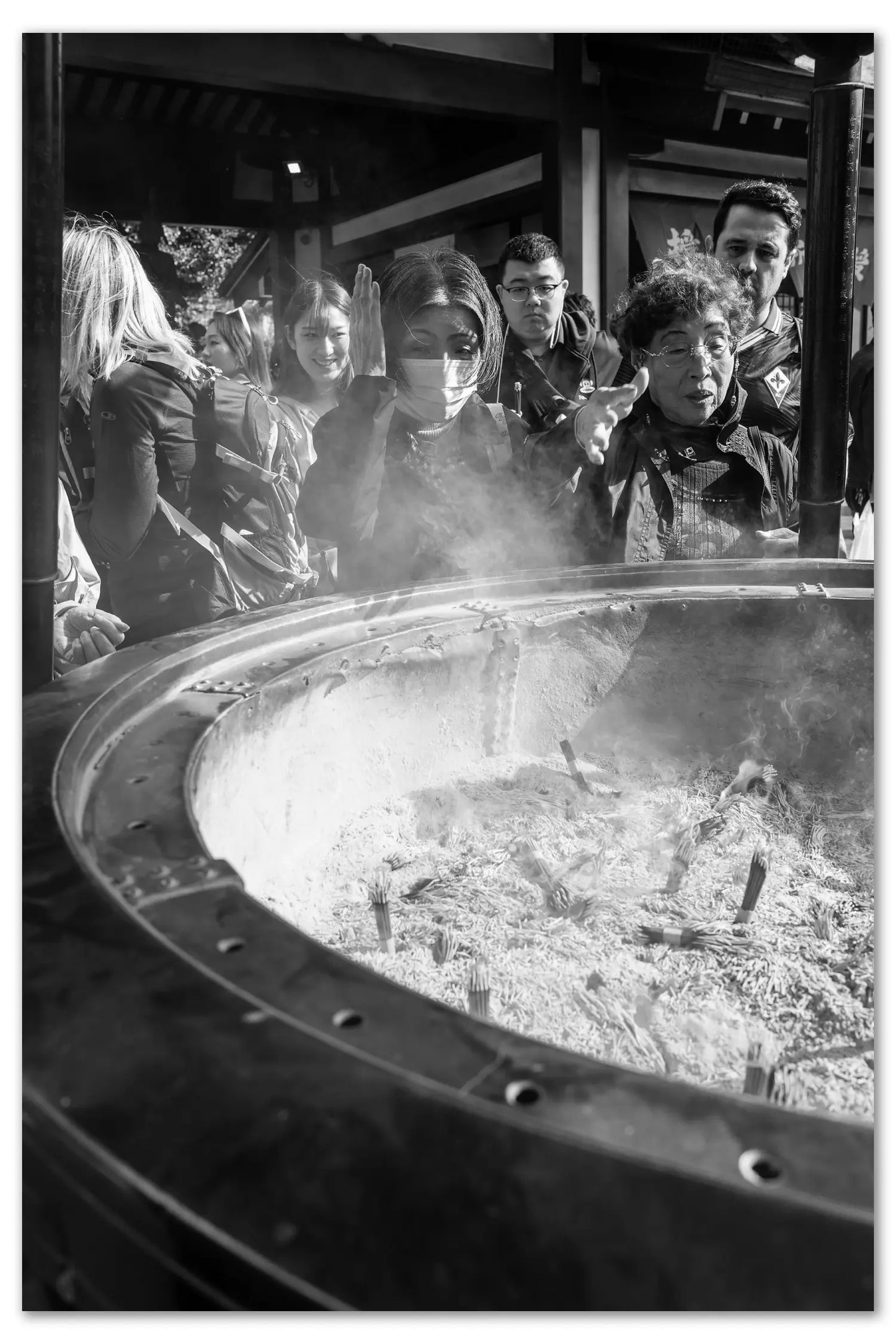 Old ladies using the smoke of incense to purify at Sensoji Temple.