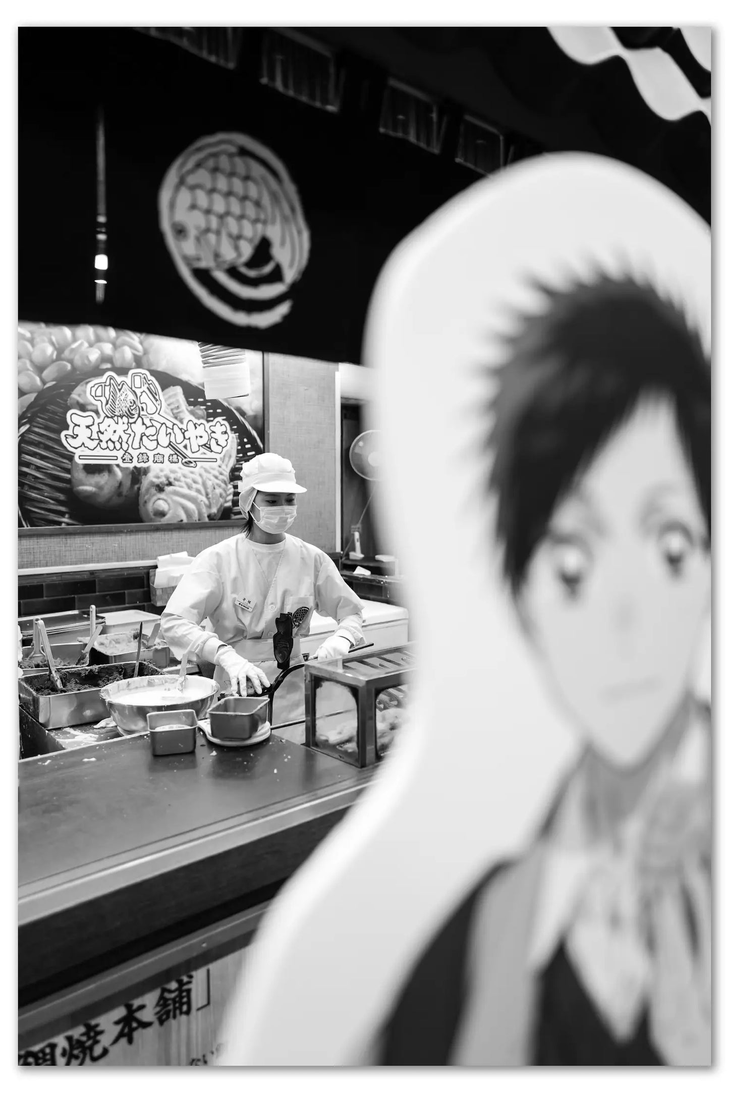 A woman makes Taiyaki at a restaurant near Sensoji Temple.